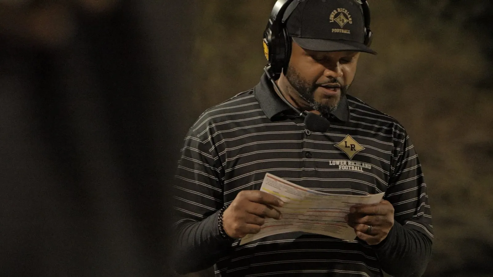 A coach reading the call sheet